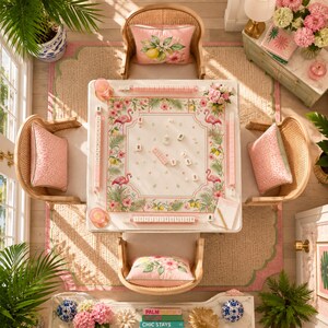 May include: A square game table featuring a white surface with a pink flamingo, hibiscus flower, and lemon botanical border. The table includes four matching rattan chairs with pink patterned cushions, each set with a tile rack and game tiles.