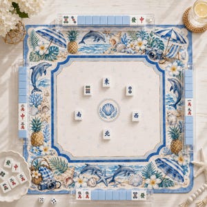 May include: A square mahjong mat featuring a coastal theme with blue and white illustrations of dolphins, pineapples, seashells, and beach umbrellas. The center displays a shell icon, surrounded by six mahjong tiles with Chinese characters.