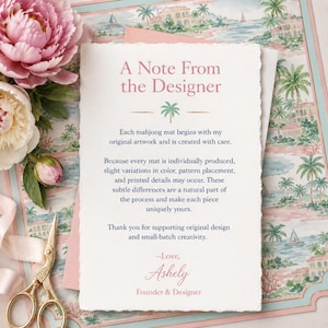 May include: A rectangular note card with deckled edges featuring the text A Note From the Designer in pink, followed by a green palm tree icon and black text explaining the production process, signed by Ashely, Founder & Designer in pink.