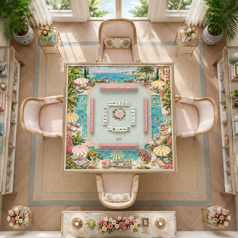 May include: A square mahjong table featuring a printed surface with a colorful poolside resort scene, surrounded by four upholstered chairs. The table surface displays a central arrangement of white mahjong tiles with various symbols.