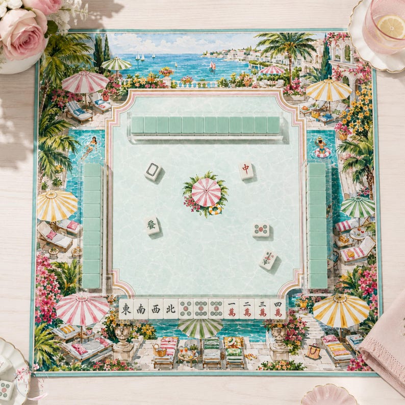 May include: A Mahjong set featuring a rectangular play mat with a coastal resort illustration, including palm trees, umbrellas, and lounge chairs. The set includes light green tiles arranged in racks and scattered on the mat, with a central floral motif.