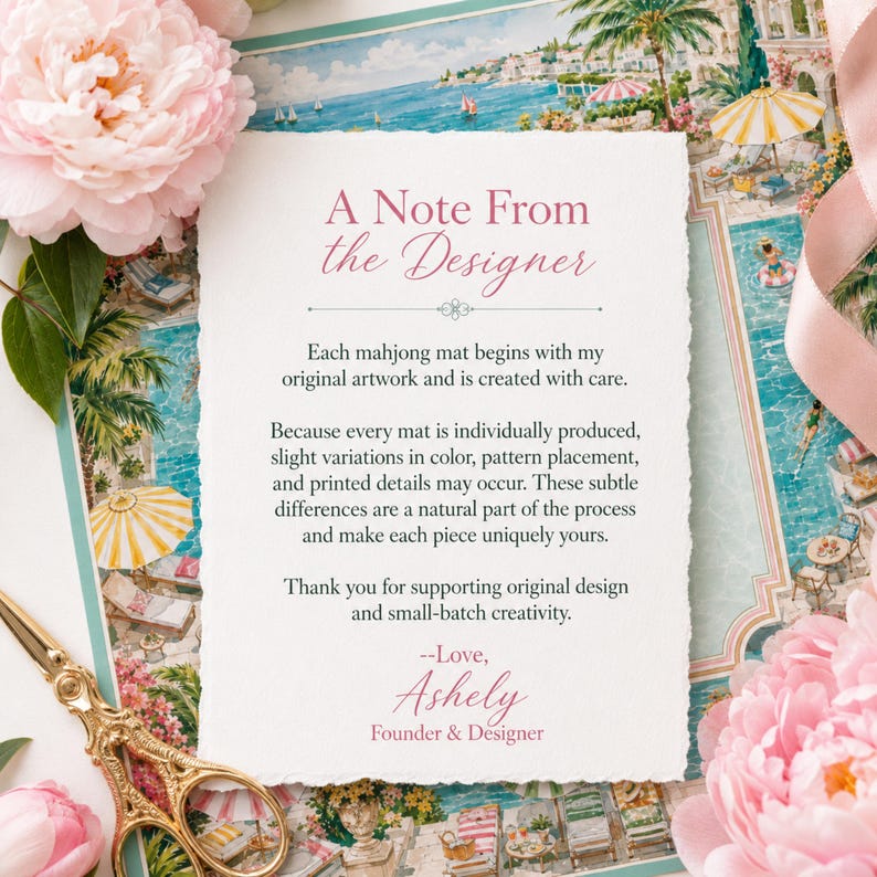 May include: A rectangular note card with deckled edges featuring the text A Note From the Designer in pink and black ink. The card explains the production process of a mahjong mat, signed by Ashely, Founder & Designer, in a pink script font.