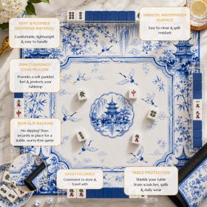 May include: A square mahjong mat featuring a blue and white chinoiserie pattern with pagodas, cranes, and bamboo. The mat includes a non-slip backing, a 2mm cushioned construction, and a smooth, waterproof surface. It is foldable and includes mahjong tiles.