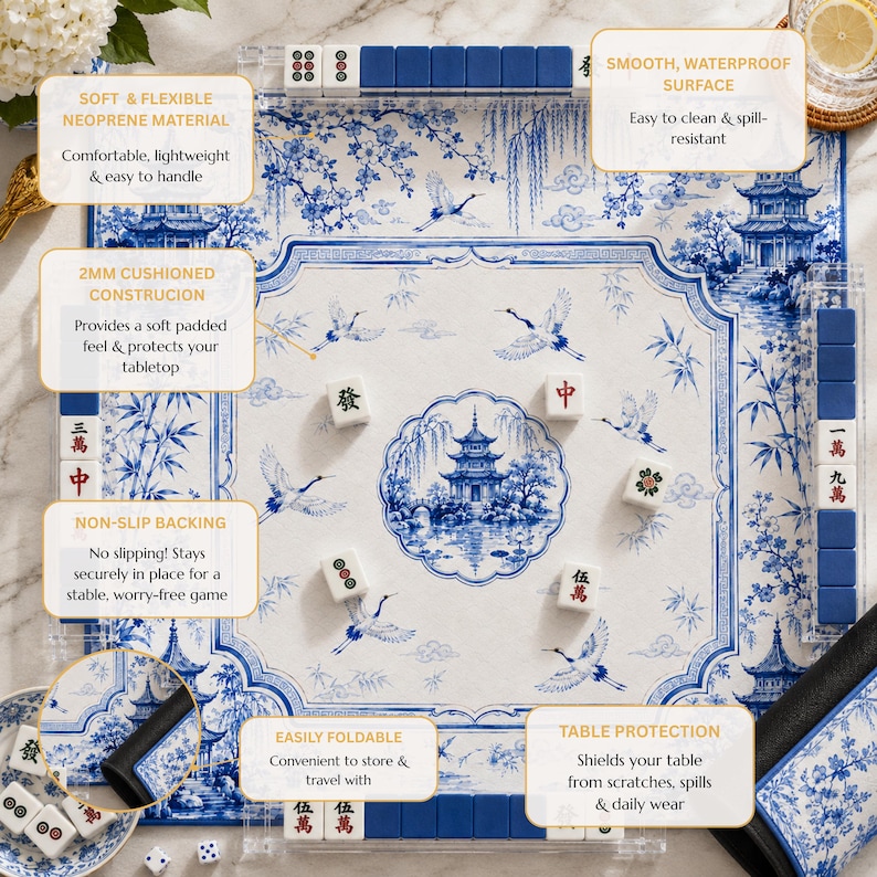 May include: A square mahjong mat featuring a blue and white chinoiserie pattern with pagodas, cranes, and bamboo. The mat includes a non-slip backing, a 2mm cushioned construction, and a smooth, waterproof surface. It is foldable and includes mahjong tiles.