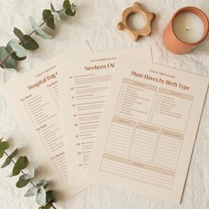 May include: Three off-white paper sheets titled Longoco Birth Bundle featuring checklists for Hospital Bag, Newborn FAQ, and Must-Haves by Birth Type with brown text, arranged with a wooden ring and a terracotta candle holder.