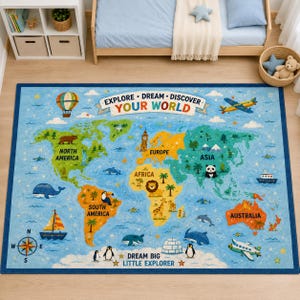 May include: A rectangular area rug featuring a colorful world map with continents labeled North America, South America, Europe, Africa, Asia, and Australia. The design includes illustrations of animals, a hot air balloon, a ship, and airplanes, with the text EXPLORE DREAM DISCOVER YOUR WORLD and DREAM BIG LITTLE EXPLORER.