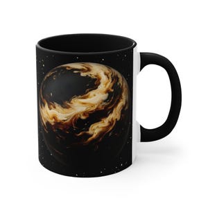 May include: A black ceramic mug featuring a graphic of a spherical planet-like object with swirling cream and dark brown liquid patterns against a black background filled with small white dots resembling stars in outer space.