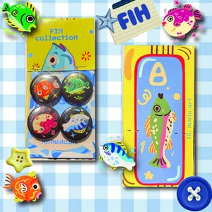 May include: A set of four circular pin-back buttons featuring colorful fish illustrations on a yellow backing card labeled FIH collection, alongside a rectangular yellow card with a central blue panel depicting a single fish and the text nuulu.art.