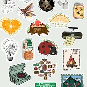 May include: A collection of assorted stickers featuring illustrations of a lightbulb, binoculars, a ladybug, a lighter, a firefly jar, orange slices, a tree stump with an apple, a rearview mirror with a note, a juice carton, a record player, and a Vermont license plate.