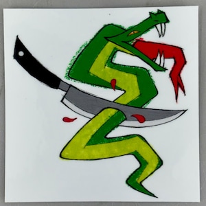 May include: A square sticker featuring a graphic illustration of a green snake with a red tongue and sharp fangs. A large kitchen knife with a black handle and a grey blade is positioned horizontally across the snake's body, with small red droplets.