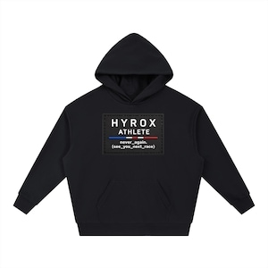 May include: A black hooded sweatshirt featuring a rectangular patch on the chest. The patch displays the white text HYROX ATHLETE above a blue, white, and red horizontal line, followed by the text never_again. (see_you_next_race) in white.