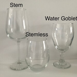 May include: Three clear glass wine glasses: a stemmed wine glass labeled "Stem", a stemless wine glass labeled "Stemless", and a water goblet labeled "Water Goblet".
