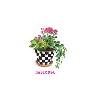 May include: A black and white checkered planter with pink flowers and green leaves. The planter has a brown rim and the name "Susan" is written below it.
