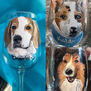 May include: Two wine glasses with painted portraits of dogs. The first glass features a brown and white dog with the name "Charlie" painted on the glass. The second glass features a brown, white, and black dog with the name "Kaldr" painted on the glass.