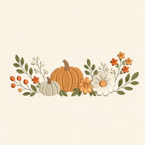 May include: An embroidery design on cream fabric featuring a central orange pumpkin flanked by a smaller white pumpkin, various green leaves, orange berries, and white and orange flowers arranged in a horizontal botanical composition.