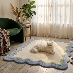 Cat lying on scalloped area rug with wavy border, styled near curtains in a cozy room corner