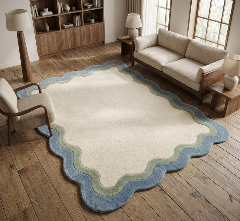 Scalloped wavy border rug with blue edge placed in a rustic living room with wooden furniture and natural light