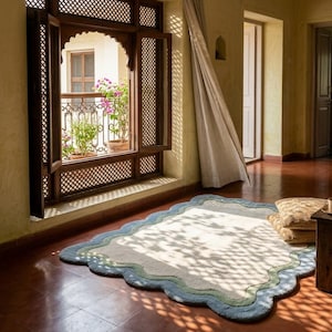 Scalloped area rug with wavy border placed near an arched wooden doorway on terracotta tiled flooring