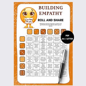 May include: A Building Empathy Roll and Share game sheet with an orange border, a yellow emoji holding a sign that says I am here for you, a grid of questions, dice icons, and a black circle with the text PDF A4 / LETTER, plus a silver pen.