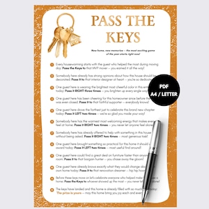 May include: A printable game sheet titled Pass The Keys with a gold-toned border and a graphic of a house-shaped keychain. The document contains eleven numbered instructions for a housewarming party and includes a black and silver ballpoint pen.