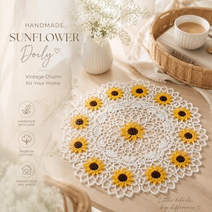 May include: A round white crocheted doily featuring a central sunflower motif surrounded by a ring of smaller sunflower appliques. The doily has an intricate openwork lace pattern with yellow petals and dark brown centers on each sunflower.