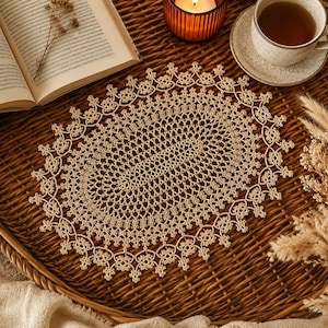 May include: An oval-shaped beige lace doily featuring an intricate, repeating knotted pattern with a decorative scalloped edge. The textile piece displays a fine, openwork design crafted with delicate thread, showcasing a symmetrical floral motif.