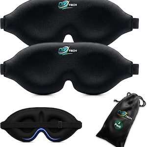May include: Two black contoured sleep masks with adjustable elastic straps and the OZ TECH logo printed in blue and green. The set includes a black drawstring storage pouch with the OZ TECH logo and a 2 Pack label. The interior shows blue trim.