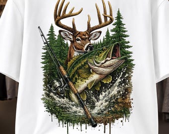 May include: A white t-shirt featuring a graphic print of a brown deer with large antlers, a green fish jumping out of water, and a fishing rod. The design includes a background of green pine trees and water splashing, with a paint drip effect at the base.