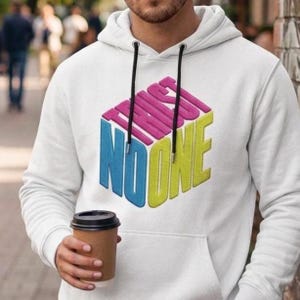 May include: A white hooded sweatshirt featuring a graphic design of a three-dimensional cube with the text "TRUST NO ONE" printed in pink, blue, and yellow. The hoodie includes a front kangaroo pocket and black drawstrings with silver metal tips.