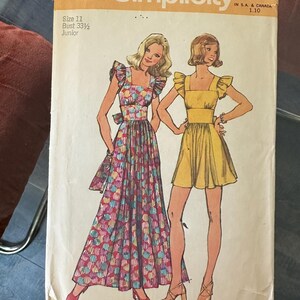 May include: Vintage Simplicity sewing pattern, number 5670, featuring illustrations of two dresses. One is a long, patterned dress, and the other is a short, yellow dress. The pattern includes sizing information for a bust of 33 1/2 inches.