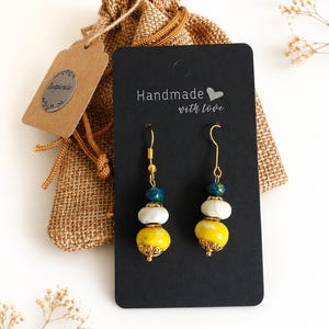 Handmade yellow, white and Blue Dangle Earrings with gold coloured hooks made with polymer clay.