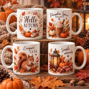 Könnte beinhalten: Vier weiße Keramiktassen mit herbstlichen Illustrationen. Die Motive zeigen einen Hello Autumn-Kranz mit Kürbissen, einen Pumpkin Spice Season-Latte, ein Eichhörnchen mit dem Text Croquer LA VIE und eine Laterne mit Simple moments.