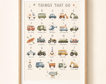 Peut inclure: Une affiche éducative encadrée intitulée THINGS THAT GO, présentant un alphabet illustré à l'aquarelle avec divers véhicules de A à Z, incluant une ambulance, un bus, une voiture, une pelleteuse, un camion de pompiers et un zeppelin.