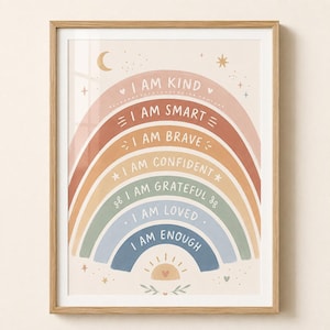 May include: A framed wall art print featuring a rainbow with seven colored arches in muted tones. Each arch contains text: I AM KIND, I AM SMART, I AM BRAVE, I AM CONFIDENT, I AM GRATEFUL, I AM LOVED, and I AM ENOUGH. The design includes stars, a moon, and a sun.