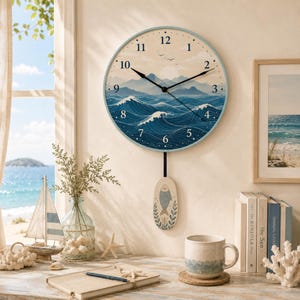 May include: A round wall clock with a light blue frame featuring a printed illustration of a sunlit mountain range above dark blue ocean waves. The clock has black hands and a pendulum shaped like an oval with a fish and leaf design.