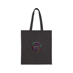 May include: A black tote bag featuring a central circular graphic composed of swirling, vibrant rainbow-colored ribbons. The text BySubject is printed in white in the center of the colorful spiral design, set against the solid black fabric.