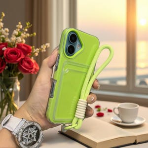 May include: A bright lime green smartphone case featuring a built-in card slot on the back and a matching lime green wrist strap with a textured knot detail. The case has a clear border and a cutout for a dual-lens camera system.