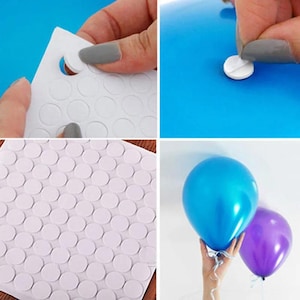 May include: A sheet of white circular adhesive dots used for balloon decoration. The image shows the process of peeling a single white adhesive dot from the backing sheet and applying it to the surface of a shiny blue balloon.