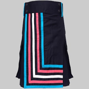 May include: A navy blue kilt featuring a high waistband with two dark buttons. The front panel displays a geometric pattern of vertical and horizontal stripes in bright pink, white, and cyan blue, contrasting against the dark fabric base.