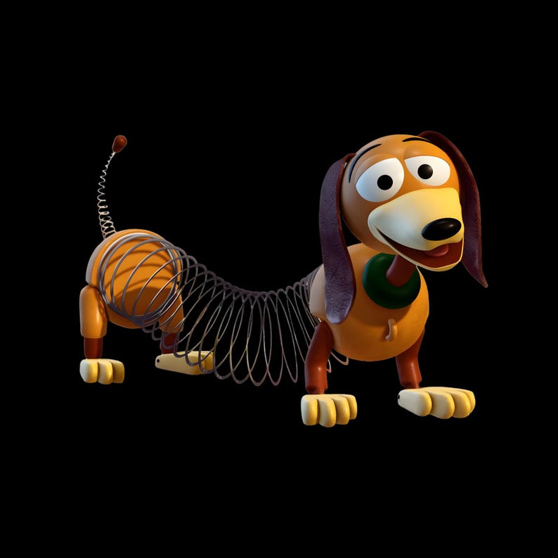 May include: A toy dachshund with a brown plastic head, long floppy ears, and a green collar. The body consists of a flexible metal coil spring connecting the front and back sections, which feature brown legs and cream-coloured paws. A thin metal spring tail is attached to the rear.