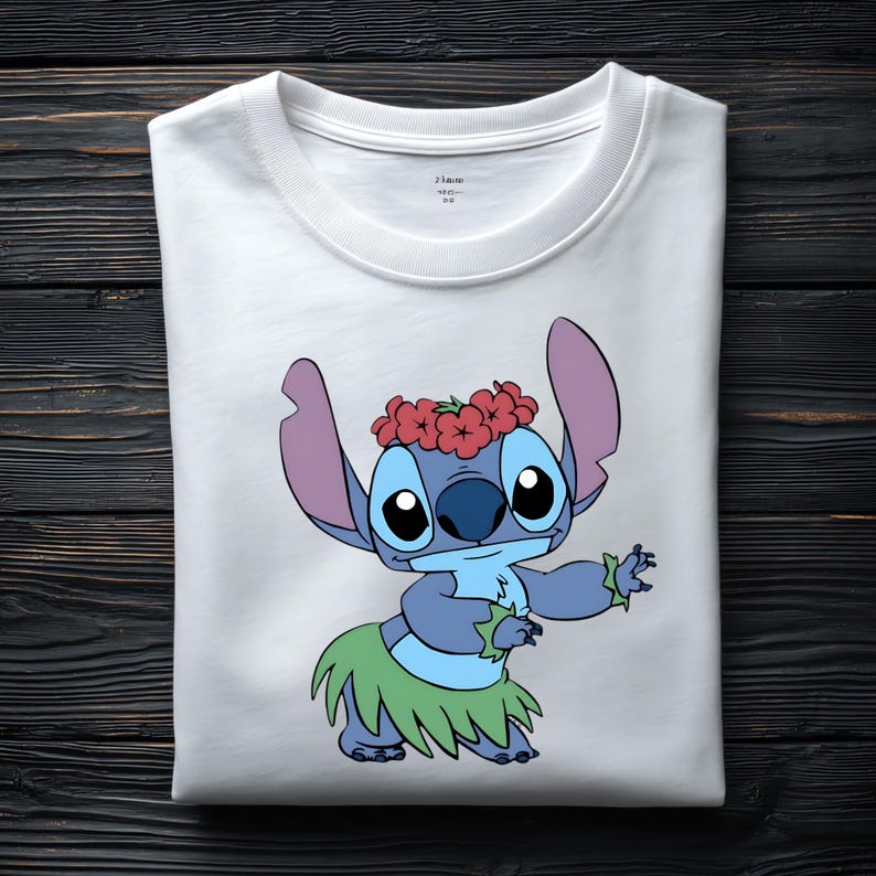 May include: A white crew neck t-shirt featuring a graphic print of the blue character Stitch wearing a red flower crown and a green hula skirt. The character is depicted in a dancing pose with arms extended. The shirt has a simple round neckline.