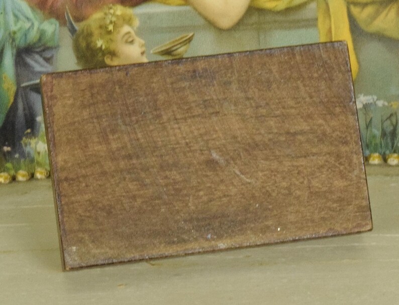 K&ouml;nnte beinhalten: Ein rechteckiger Holzblock mit dunkelbraun gebeizter Oberfl&auml;che und sichtbarer Holzmaserung. Das Objekt hat gerade, definierte Kanten und eine flache, feste Oberfl&auml;che, was ein schlichtes, unverziertes Erscheinungsbild mit einheitlichem Farbton ergibt.