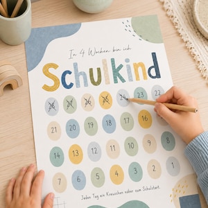 May include: A countdown poster titled In 4 Wochen bin ich Schulkind with a grid of numbered circles from 1 to 28 in muted blue, yellow, and beige tones. The poster features abstract shapes and the text Jeden Tag ein Kreuzchen näher zum Schulstart.