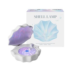 May include: A white shell-shaped lamp with an open lid revealing a glowing purple rippled light effect. The packaging box behind it features the text SHELL LAMP, Z6, and lists features including wave projection, Bluetooth speaker, and white noise.