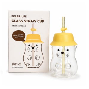May include: A clear glass cup shaped like a sea otter with a yellow hat lid and a straw featuring a small yellow fish. The packaging box displays the text POLAR LIFE GLASS STRAW CUP, Hat Sea Otter, Drink Slowly~ Live Cozily~, and 450ml/15.22 oz.