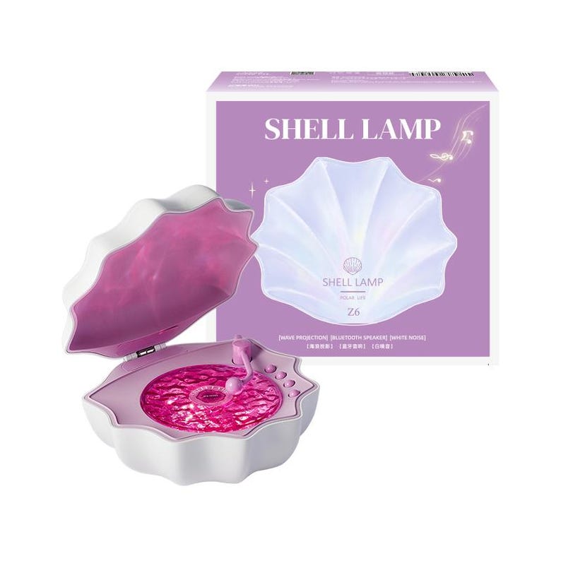 May include: A white shell-shaped lamp with a pink interior and a circular pink light projection base. The packaging box is purple and features the text SHELL LAMP Z6, along with icons and text indicating wave projection and Bluetooth speaker.