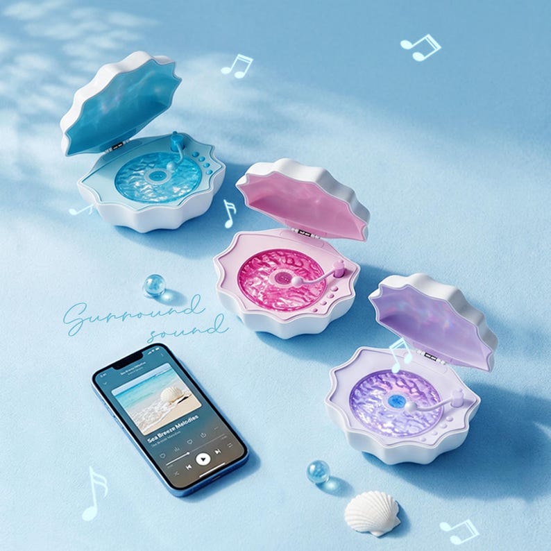 May include: Three clam-shaped Bluetooth speakers in blue, pink, and purple, each with a white exterior and a textured interior disc. A smartphone displays a music interface with the text "Surround sound" nearby, accompanied by floating musical note icons.