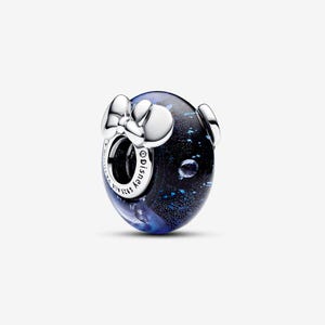 May include: A round charm bead featuring a dark blue glass body with shimmering blue flecks and a polished silver metal bow accent. The silver core is engraved with the text Disney and S925 ALE, indicating the metal composition and brand origin.
