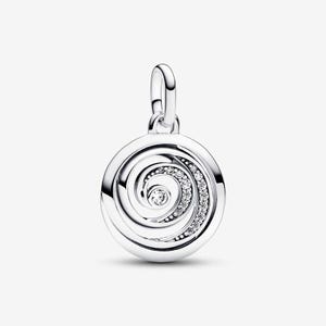 May include: A circular silver charm featuring a polished metal finish and a central spiral design. One side of the spiral is embellished with a row of small, clear, round-cut stones that follow the curve, leading to a single stone at the center.