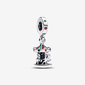 May include: A silver charm shaped like a carousel with a roof featuring green and red enamel details. The charm includes small blue and red stones along the edge and the word PANDORA engraved on the top loop, which is accented with star-shaped cutouts.